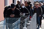     Køerne er lange i de franske supermarkeder. Alle butikker undtagen levnedsmiddelbutikker er lukkede, og efter hård kritik for tøven og manglende handlekraft ventes præsident Emmanuel Macron at bebude nye skærpelser i en tale kl. 20.  Foto: Patrick Hertzog/Ritzau Scanpix