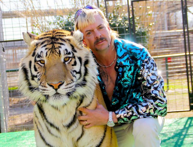 Joe Exotic er en homoseksuel, skydegal cowboy, der ejer en zoo med tigre.  Her tjener han penge på at avle, sælge og lade gæster kæle med tigerungerne.  Foto: Netflix
