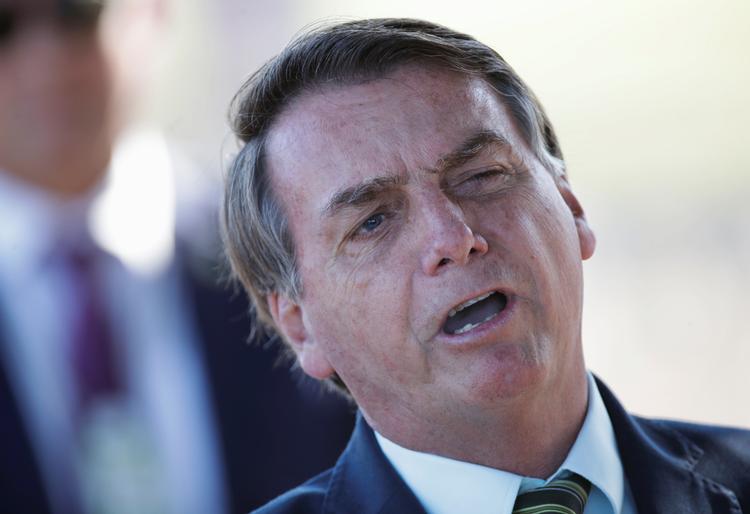 De stigende tal for syge og døde i Brasiliens største byer er politisk motiverede, mener præsident Jair Bolsonaro, der kalder coronavirussen for »en lille forkølelse«.  Foto: Ueslei Marcelino/Ritzau Scanpix