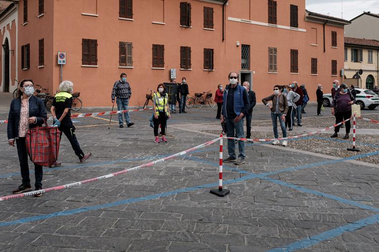 Køkultur. Italienerne har lært de vigtige forholdsregler mod coronaen. Her står folk i kø for at komme ind på et genåbnet marked med fødevarer i Codogno.Men der er delte meninger om, hvorvidt de ligefrem skal lade sig overvåge af en sporinsgapp. 

   Foto: Marzio Toniolo/Ritzau Scanpix