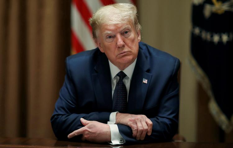 Den amerikanske præsident Donald Trump truer i et fire sider langt brev WHO med at gøre sin fastfrysning af donationer permanent, hvis ikke FN-organisationen viser, at den ikke er afhængig af Kina. Foto: Leah Millis/Ritzau Scanpix