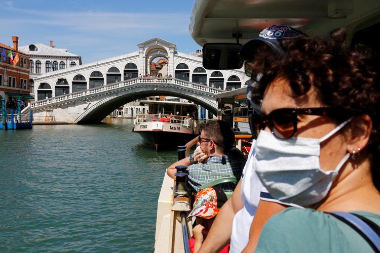  turister bærer maske på en sejltur i Venedig. Italien har søndag registreret 24 dødsfald, og det er det laveste tal siden marts.  Foto: Fabrizio Bensch/Ritzau Scanpix
