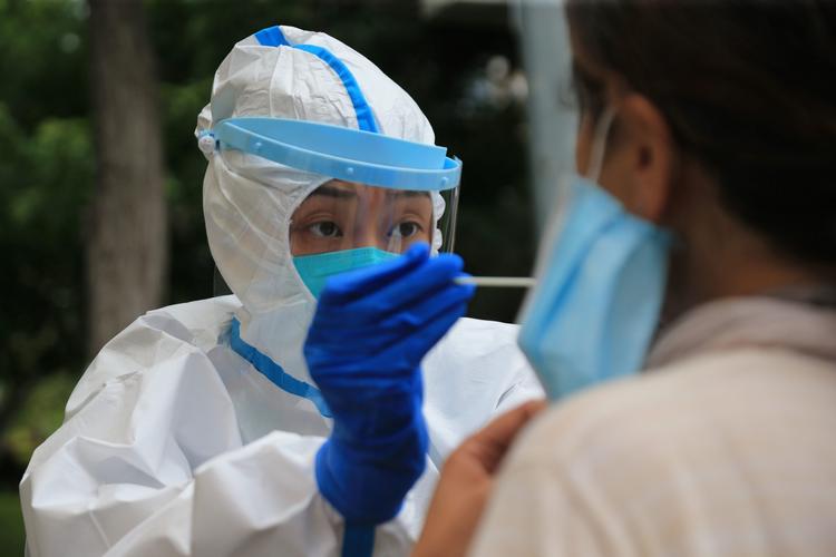En sundhedsmedarbejder tester en person for coronavirus i Dalian, der ligger i Kinas nordøstlige provins Liaoning. Foto: Str/Ritzau Scanpix