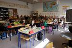 Liva Maria Rye Færch Nielsen (forrewst) og hendes klassekammerater i 2.b. er tilbage i klasselokalet på Skovlunde Skole. Liva er glad for, at legepladsen er tilbage som før: »Det var irriterende, når man ikke kunne komme til rutsjebanen. Men nu må vi være over det hele«. Foto: Jesper Houborg/POLFOTO