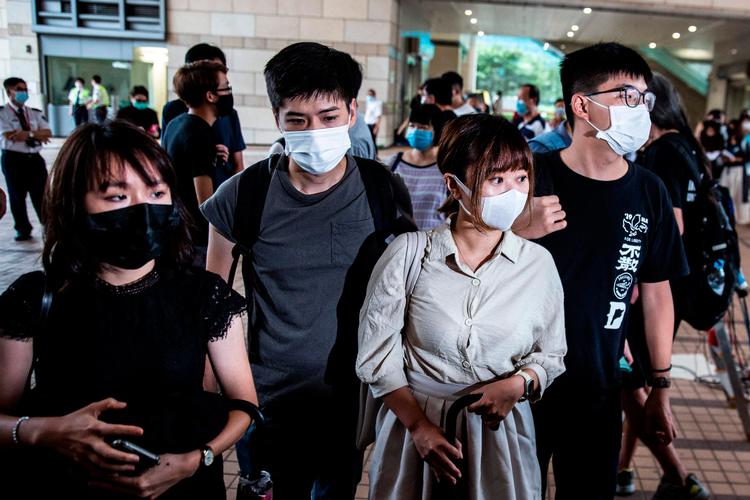 Aktivisterne Jannelle Leung, Lester Shum, Tiffany Yuen og Joshua Wong. Foto: Isaac Lawrence/Ritzau Scanpix