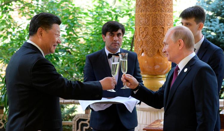 Xi Jinping og Vladimir Putin skåler inden en konference i Tajikistan i 2019. Nu vil både Kina og Rusland have en plads i et menneskerettighedsbeskyttende råd. Som at ansætte brandstiftere i brandvæsenet, kalder UN Watch det. 

 Foto: Alexei Druzhinin/Ritzau Scanpix