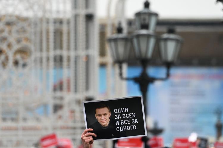 Et billede af Aleksej  Navalnyj holdes oppe af en demonstrant i Moskva. Foto: Kirill Kudryavtsev/Ritzau Scanpix