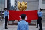 Politifolk under en flagceremoni i Hongkong, der også markerer loyalitet over for Kina. Foto: Lam Yik/Ritzau Scanpix