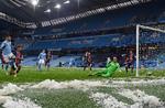 Resterne af nogle voldsomme haglbyger lå stadig på Etihad Stadiums græstæppe, da Manchester Citys Riyad Mahrez (tv.)  bragte sit hold foran i starten af Champions League-opgøret tirsdag aften.  Foto: Paul Ellis/Ritzau Scanpix
