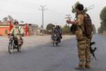 En afghansk soldat styrer trafikken her i provinsen Kandahar. Foto: Danish Siddiqui/Ritzau Scanpix
