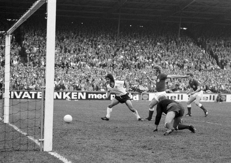 Den tyske angriber Gerd Müller udligner til 1-1 i venskabskampen mellem Danmark og Vesttyskland i juni 1971. Vesttyskerne ender med at vinde kampen 3-1. Den kravlende målmand var Erik Lykke, som ikke var helt uskyldig i Müller-scoringen. Fem år senere var Müller igen i København, hvor han scorede to mål mod Køge i mesterholdenes Europa Cup Foto: Lars Hansen/POLFOTO