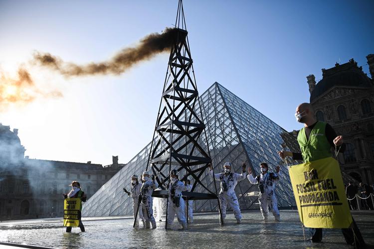     Greenpeace aktivister protesterede 6. oktober foran pyramiden ved Louvre mod Totals fortsatte investeringer i produktion af fossile brændstoffer.  Foto: Anne-christine Poujoulat/Ritzau Scanpix