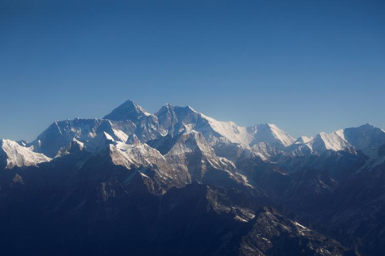 Mount Everest, verdens højeste bjergtinde, og andre tinder i Himalaya-bjergkæden set gennem  vinduet i et fly på vej fra Kathmandu. Foto: Monika Deupala/Ritzau Scanpix