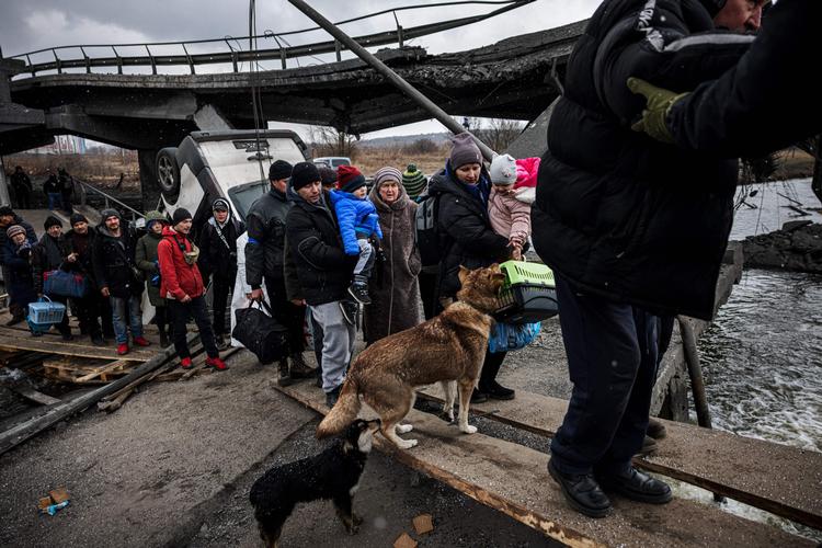 Ukrainere under evakuering fra byen Irpin nord for Kyiv. På et medie som Sputnik, hvor der slet ikke er tale om nogen russisk invasion, er det snarere billeder af stille gader, man ser fra den ukrainske hovedstad.  Foto: Dimitar Dilkoff/Ritzau Scanpix