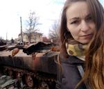 Anna Pantyukhova foran en af de mange udbrændte russiske kampvogne i gaden Vokzal’na i Butja.
»Det kan lyde forkert, men det syn gjorde mig helt ærligt glad« Foto: Privatfoto