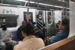     NEW YORK, NEW YORK - APRIL 13: People ride a Brooklyn subway a day after a man shot numerous people on a Manhattan bound train in the Sunset Park neighborhood of Brooklyn on April 13, 2022 in New York City. A manhunt is underway for a gunman who shot 10 people, critically injuring five on the N train during Tuesday's morning rush hour. The suspect, wearing a gas mask, tossed smoke grenades on the floor and fired 33 shots before leaving the scene. At least 13 other commuters suffered injuries due to smoke inhalation, falls, and panic attacks. The police on Tuesday evening named a "person of interest" in the mass shooting and believe that they have found his personal belongings left on the train that includes a Glock 9-millimeter handgun and a key to a U-Haul van. Mayor Eric Adams this morning announced that Frank James, the "person of interest" is now considered a suspect. Spencer Platt/Getty Images/AFP == FOR NEWSPAPERS, INTERNET, TELCOS &amp; TELEVISION USE ONLY ==   Foto: Spencer Platt/Ritzau Scanpix