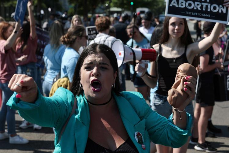     WASHINGTON, DC - JUNE 13: An anti-abortion activist holds a plastic shaped fetus as she demonstrates in front of the U.S. Supreme Court Building on June 13, 2022 in Washington, DC. The court continues to release opinions as the country awaits major case decisions pertaining to abortion rights, guns, religion and climate change in the the coming weeks before the end of their term. Anna Moneymaker/Getty Images/AFP == FOR NEWSPAPERS, INTERNET, TELCOS &amp; TELEVISION USE ONLY ==   Foto: Anna Moneymaker/Ritzau Scanpix