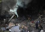 Redningsarbejdere gennemgår murbrokkerne efter et russisk missilangreb i Kharkiv. Foto: Sergey Bobok/Ritzau Scanpix