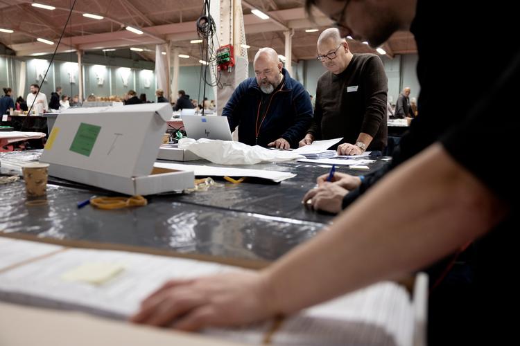 Lars Becher, i blå fleecetrøje, er ansvarlig for registreringen af stemmer ved bord 5 i Svanemøllehallen. Foto: Thomas Borberg