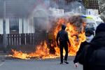 En politibil blev mandag stukket i brand af republikanske demonstranter i Londonderry i Nordirland, der marcherede på 25-års-dagen for fredsaftalen.  Foto: Clodagh Kilcoyne/Ritzau Scanpix