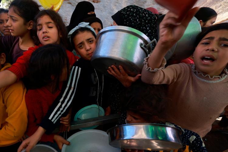 Palæstinensiske børn står i kø for at få mad i den sydlige del af Gaza torsdag, da der stadig var våbenhvile.  Foto: Mohammed Abed/Ritzau Scanpix