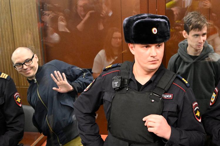 Artjom Kamardin (tv.) og Jegor Sjtovba i et glasbur i retten i dag i Moskva.  Foto: Alexander Nemenov/Ritzau Scanpix