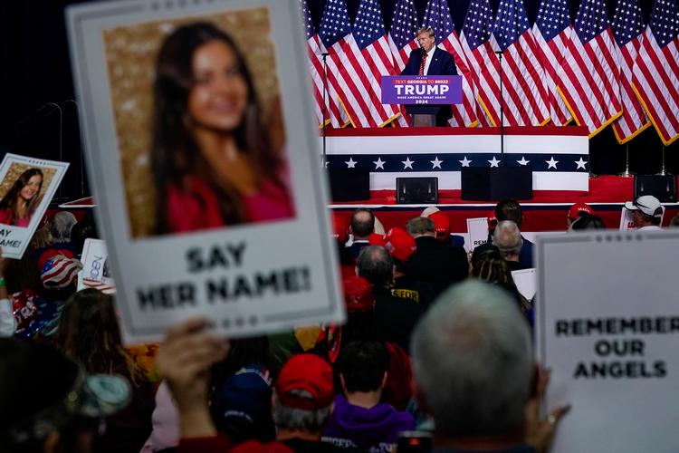 Plakater med Laken Riley og teksten: 'Sig hendes navn' blev holdt frem under Donald Trumps valgmøde i delstaten Georgia, hvor den unge kvinde blev myrdet. Foto: Elijah Nouvelage/Ritzau Scanpix