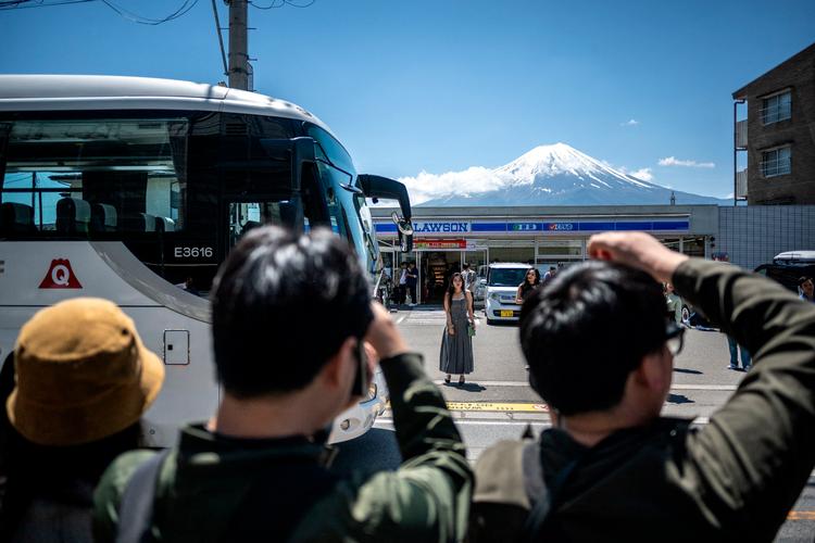 En gruppe turister tager billeder af Mount Fuji i byen Fujikawaguchiko. Bjerget, der er 3.776 meter højt og Japans højeste, og kan nås på en tur fra hovedstaden Tokyo. Foto: Philip Fong/Ritzau Scanpix