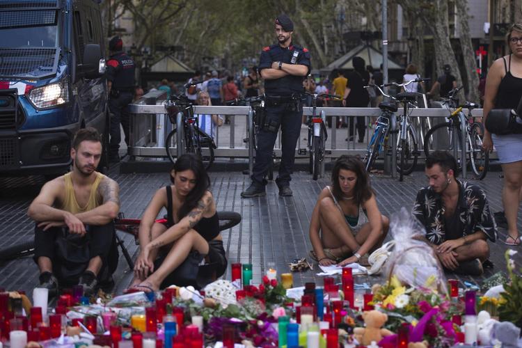 Et betjent holder vagt, mens folk mindes ofrene for angrebet på Ramblaen i Barcelona. 