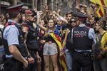 Politifolk fra lokalpolitiet Los Mossos sammen med vælgere søndag. Nu risikerer politiets ledelse sigtelse med risiko for 15 års fængsel for ikke have deltaget i forsøgene på at hindre den ulovlige folkeafstemning. 