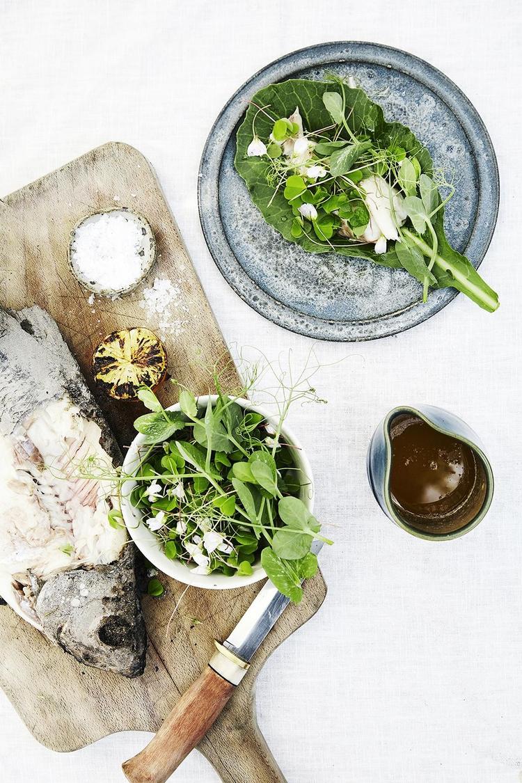 Smid hele fisken i gløderne, med skind, ben og skæl og server med grillet citron og smørsauce. 