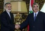 Lebanese Prime Minister Rafik Hariri (right) shakes hands with Iranian Foreign Minister Kamal Kharrazi, in Beirut on Saturday Sept. 29, 2001. 