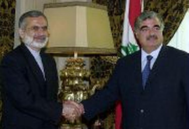 Lebanese Prime Minister Rafik Hariri (right) shakes hands with Iranian Foreign Minister Kamal Kharrazi, in Beirut on Saturday Sept. 29, 2001. 