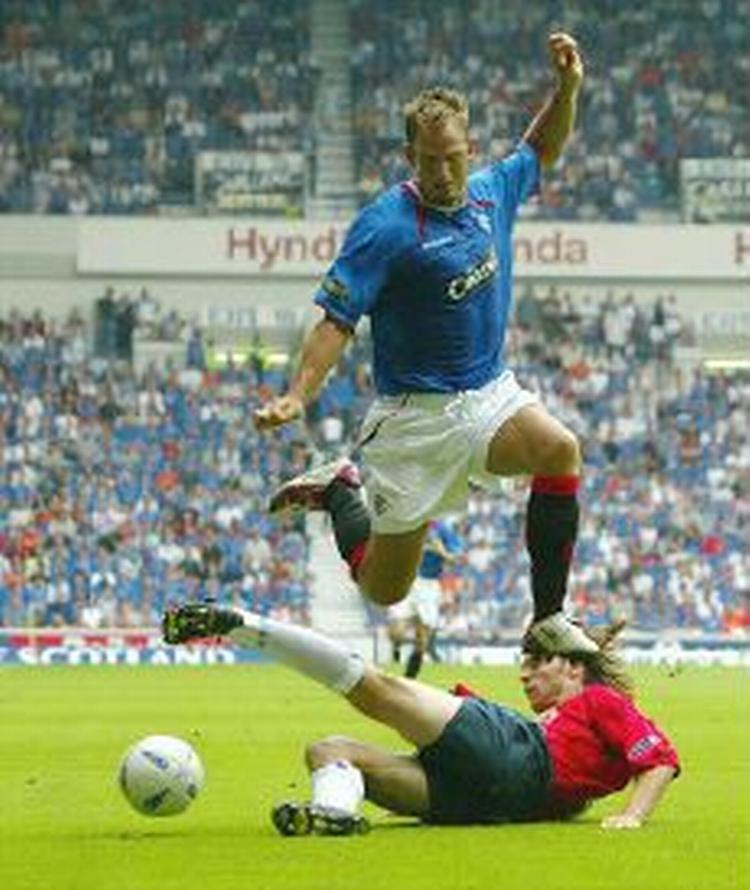 Rangers' hollandske midtbanespiller Ronald de Boer hopper over en takling fra Kilmarnocks Dindeleux. - Foto: AP 