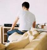 Young Man Seated on arm of Sofa