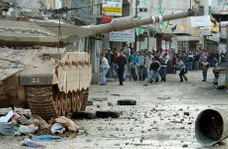 Palæstinensere kaster sten mod en israelsk tank. - Foto: AP 