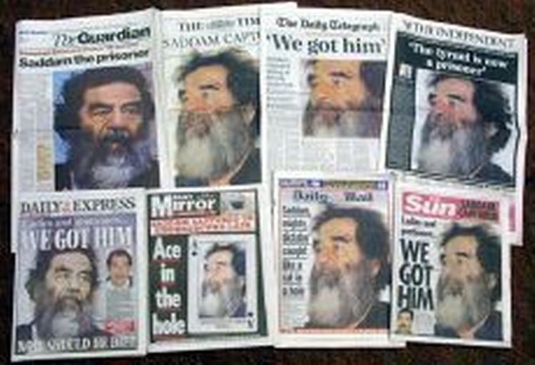 Under afhøringer har Saddam Hussein ifølge nyhedsmagasinet Time benægtet, at Irak har masseødelæggelsesvåben. Aviser verden over, her i England, har Hussein på forsiden. - Foto: AP 