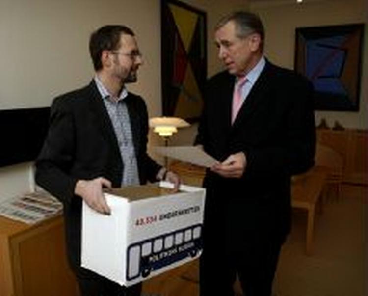 Erhvervsredaktør på Politiken, Claus Skovhus (tv), overrækker underskrifterne til trafikministeren. - Foto: Jens Dresling 