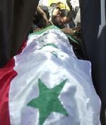 En pårørende sørger ved et offer indsvøbt i det irakiske flag efter terrorangrebne i Kerbala i Bagdad. - Foto: AP 