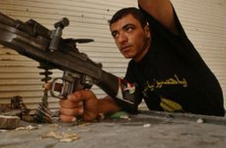 Et militsmedlem, der er tro mod Muqtada al-Sadr gør sig klar til kamp. - Foto: AP 