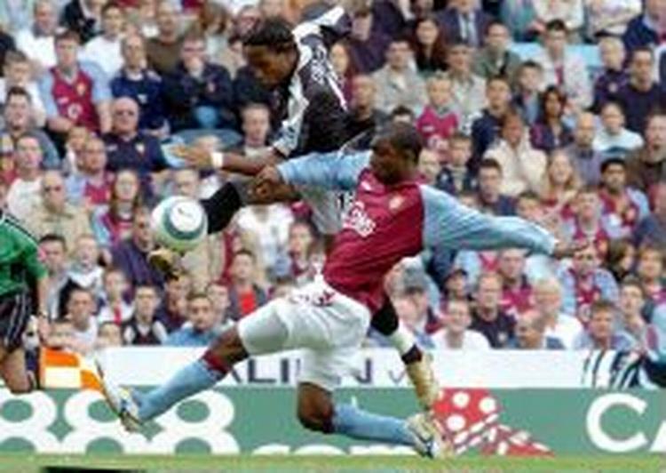 Drogba (sort trøje) fyrer af for næsen af Villa-backen Samuel. - Foto: AP 