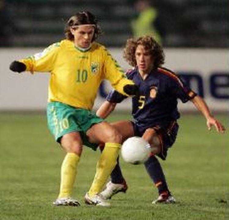 Spaniens Carlos Puyol i nærkamp med Litauens Tomas Danilevicius. - Foto: AP 