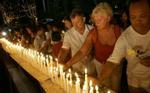 I Thailand er al udendørs fejring af nytårsaften droppet til fordel for mindeceremonier for de omkomne. Her tænder thailændere og udlændinge stearinlys for de døde i Phuket. - Foto: AP 