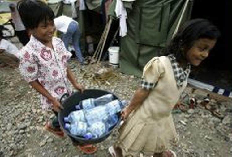 I Aceh-provinsen har man travlt med at skaffe mad samtidig at de døde skal begraves. - Foto: AP 
