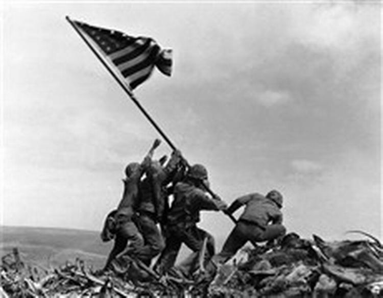Marinesoldater fra USA's 5. divisions 28. regiment sætter flaget på toppen af Suribashi på Iwo Jima i Japan 23. februar 1945. Clint Eastwoods kommende film følger gruppen og deres liv efter krigen. - Arkivfoto: Joe Rosenthal 