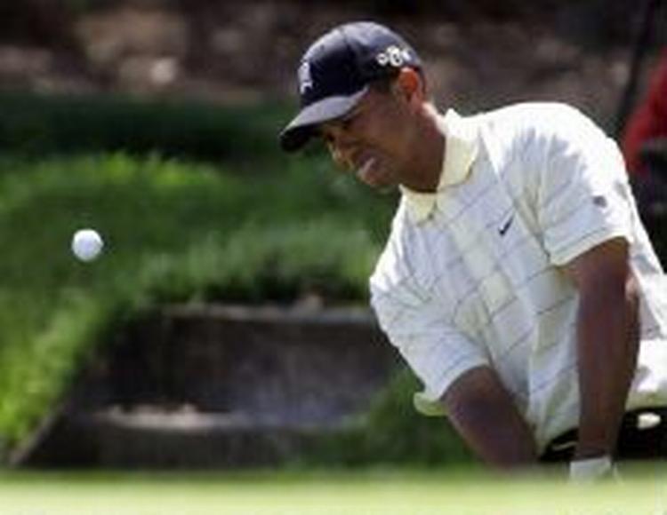 Tiger Woods på vej ud af bunkeren på 9. hul. Verdensstjernen havde en jævn dag på kontoret og sluttede sin runde med tre slag under par. - Foto: AP 