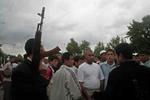 En gruppe bevæbnede oprører taler til indbyggerne i den uzbekiske by Andijan, hvor myndigheder har mistet grebet om byen, efter at op mod 2.000 demonstranter og oprører indtog byen her til morgen. - Foto: AP 