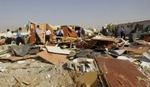 Irakiske politifolk inspicerer ødelæggelserne i Basra. Den britiske militærchef siger, at der kun skete 'mindre skader' ved aktionen i Basra. - Foto: AP 