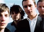 En gennemgående mørk tone i musikken har fået anmeldere til at pege på Joy Division som en af Editors' åbenlyse inspirationskilder. Og det kan godt trætte bandet en smule. - Pressefoto 