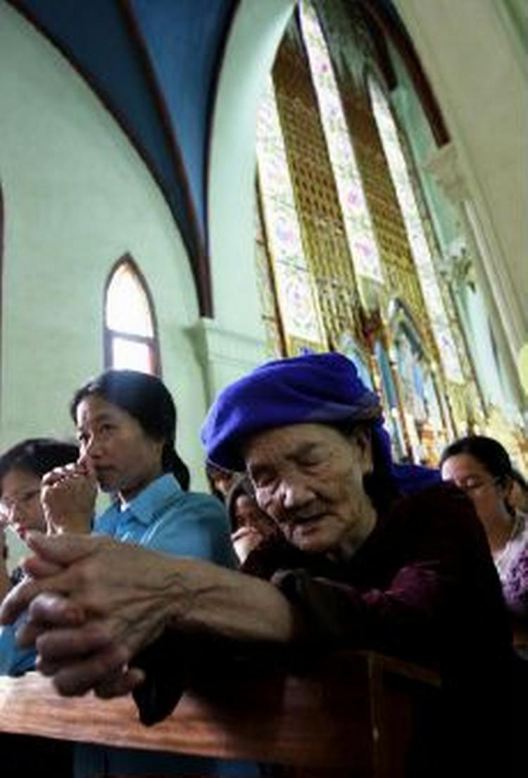Der er tøvejr mellem Vietnam og Vatikanet. Det kommunistiske land ordinerer 57 katolske præster senere på måneden. Her ses en ældre vietnameser under bøn i St. Josephs Cathedral i Hanoi. - Arkivfoto: AP 